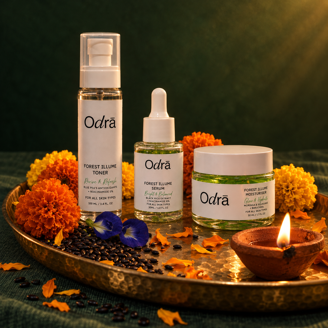 Forest Illume Ritual - toner, serum and moisturiser on a brass thali with marigolds, black rice and a lit diya